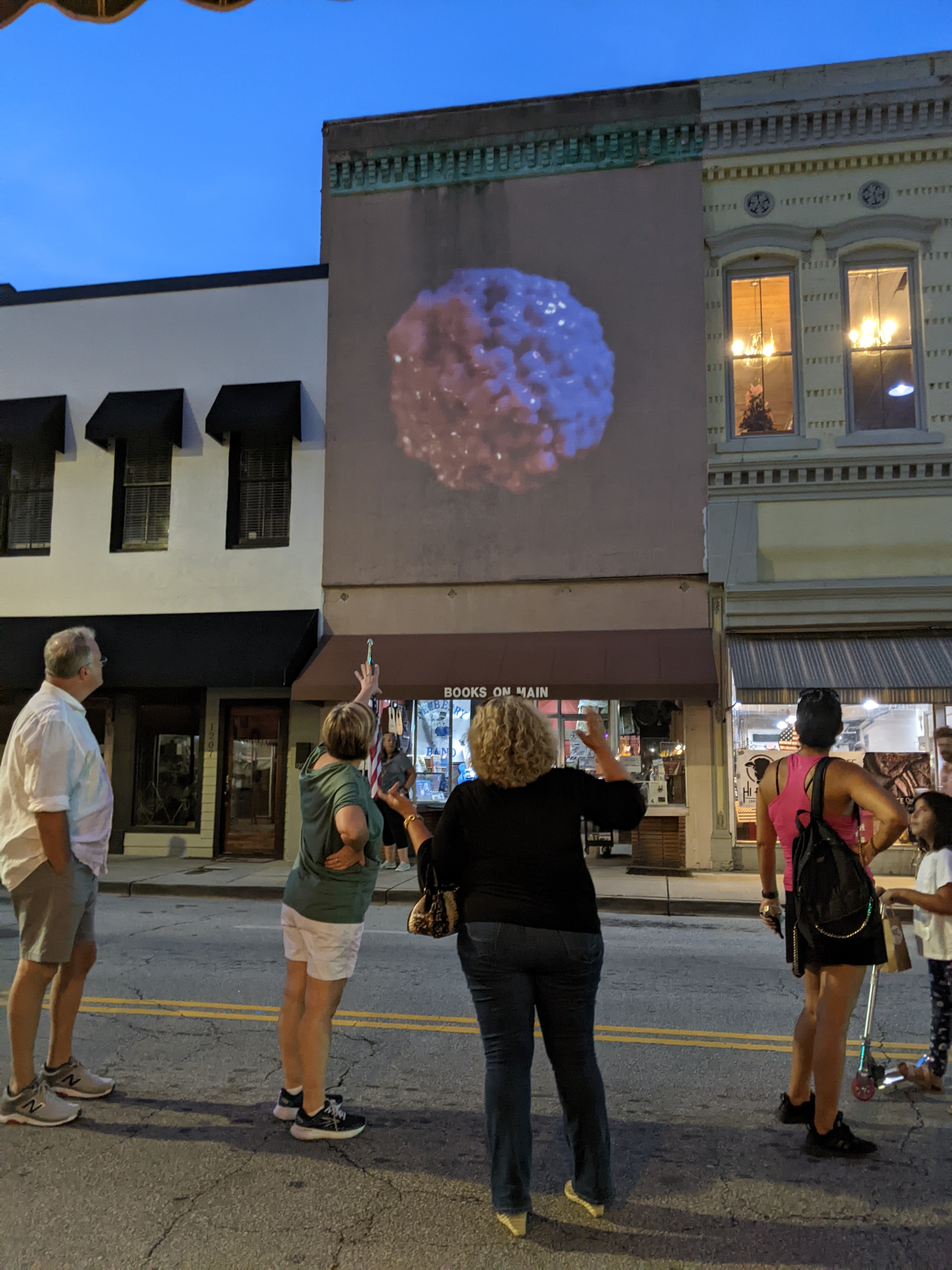 Visitors experience a NFT Museum digital mural for the first time. September 2nd, 2022. Newberry, SC USA. NFT credit @Ciphrd "My d.l.a. Cube.